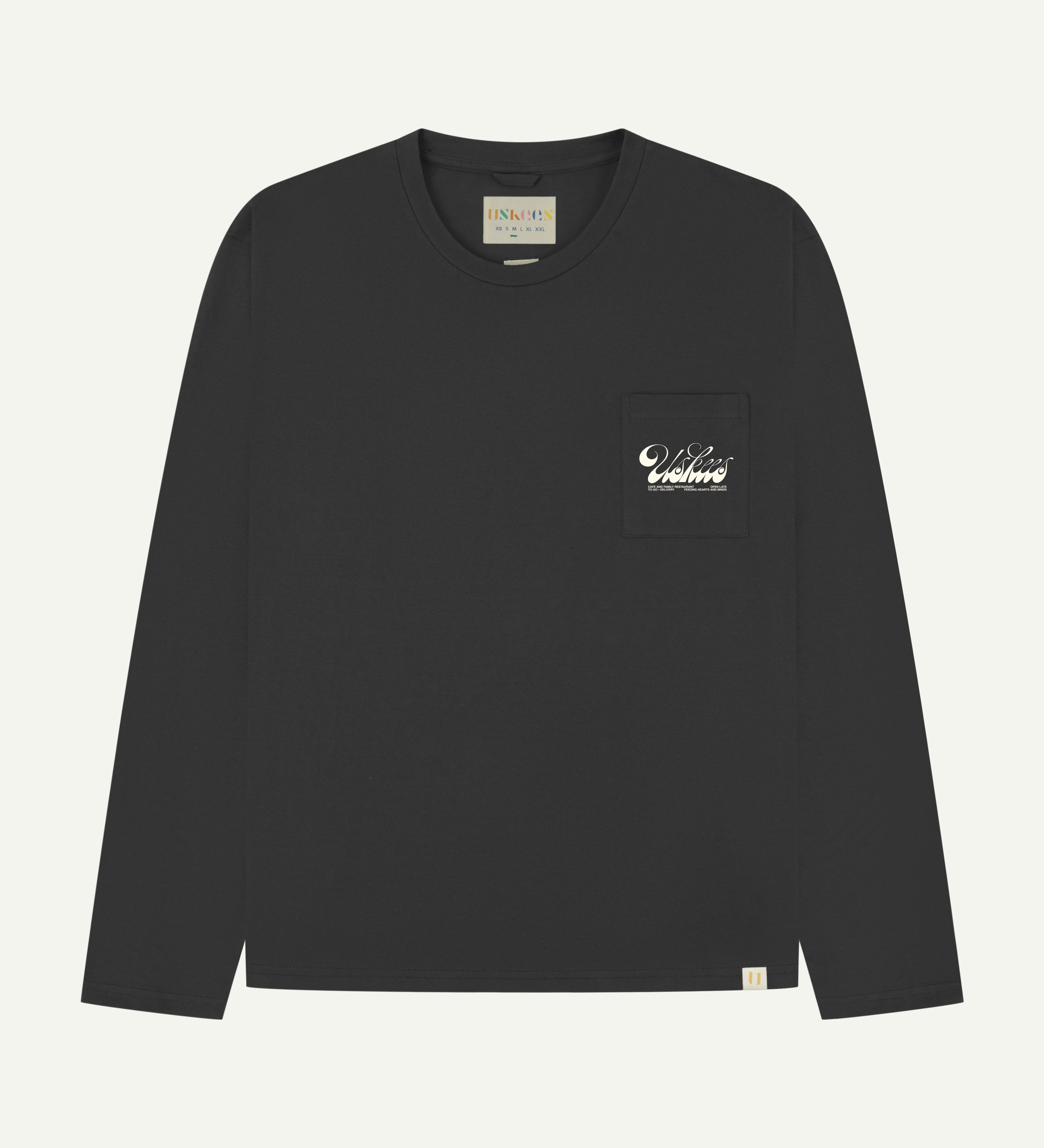 front flat shot of the uskees long sleeve graphic T-shirt for men in faded black showing the 'Diner' logo in cream on the chest pocket
