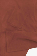 Close up shot of Uskees chestnut brown long-sleeve men's T-shirt showing the front pocket and cuff  detail.