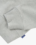 Front flat close up shot of Uskees grey marl Champ Sweatshirt for men showing the ribbed hem, cuff detail and Uskees branding label tab.