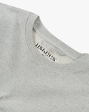 Front, flat , close up shot of Uskees grey marl Champ Sweatshirt for men showing the neckline and printed branding. 