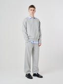 Full-length view of male model wearing Uskees 7012 gray marl sweatpants with a matching 7011 Champ sweatshirt.