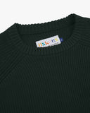 Close up view of Uskees dark green ribbed crew neck sweater for men showing neck and brand label detail.