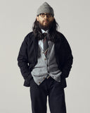 Model wearing stone-grey lambswool Harris cardigan with overcoat.