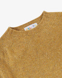 Close-up view of 7019 speckled butterscotch, Alderney crew neck jumper in Scottish new wool. Showing brand/size label, and crew neck.