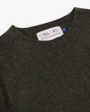 Close-up view of 7019 dark green speckled kelp, Alderney crew neck jumper in Scottish new wool. Showing brand/size label, and crew neck.