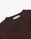 Close-up view of 7019 brown speckled walnut, Alderney crew neck jumper in Scottish new wool. Showing brand/size label, and crew neck.