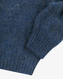 Close up view of Uskees 7021 Skye lambswool sweater in sapphire blue, with focus on the wool texture, hem and cuff.