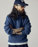 Model wearing Uskees 7021 Skye lambswool sweater in sapphire blue.
