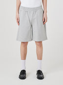 Bottom-half view of model wearing Uskees 7022 gray marl shorts indicating relaxed fit.