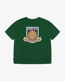 Back view of men's Uskees green graphic t-shirt with USK FC logo presented on a white background.