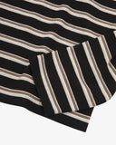 Close up view of an Uskees striped men's rugby shirt showing the black/cream/brown stripes.