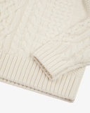 Close up view of Uskees cream-coloured men's chunky cable knit jumper showing the sleeve, cuff and welt detail.