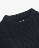 Close up view of Uskees dark blue men's chunky cable knit jumper showing the neck and pattern detail.