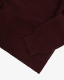 Close up of an Uskees dark red men's jumper showing the cuff and ribbed welt detail.