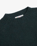 Close up of the neckline of an Uskees dark blue/green men's sweater.