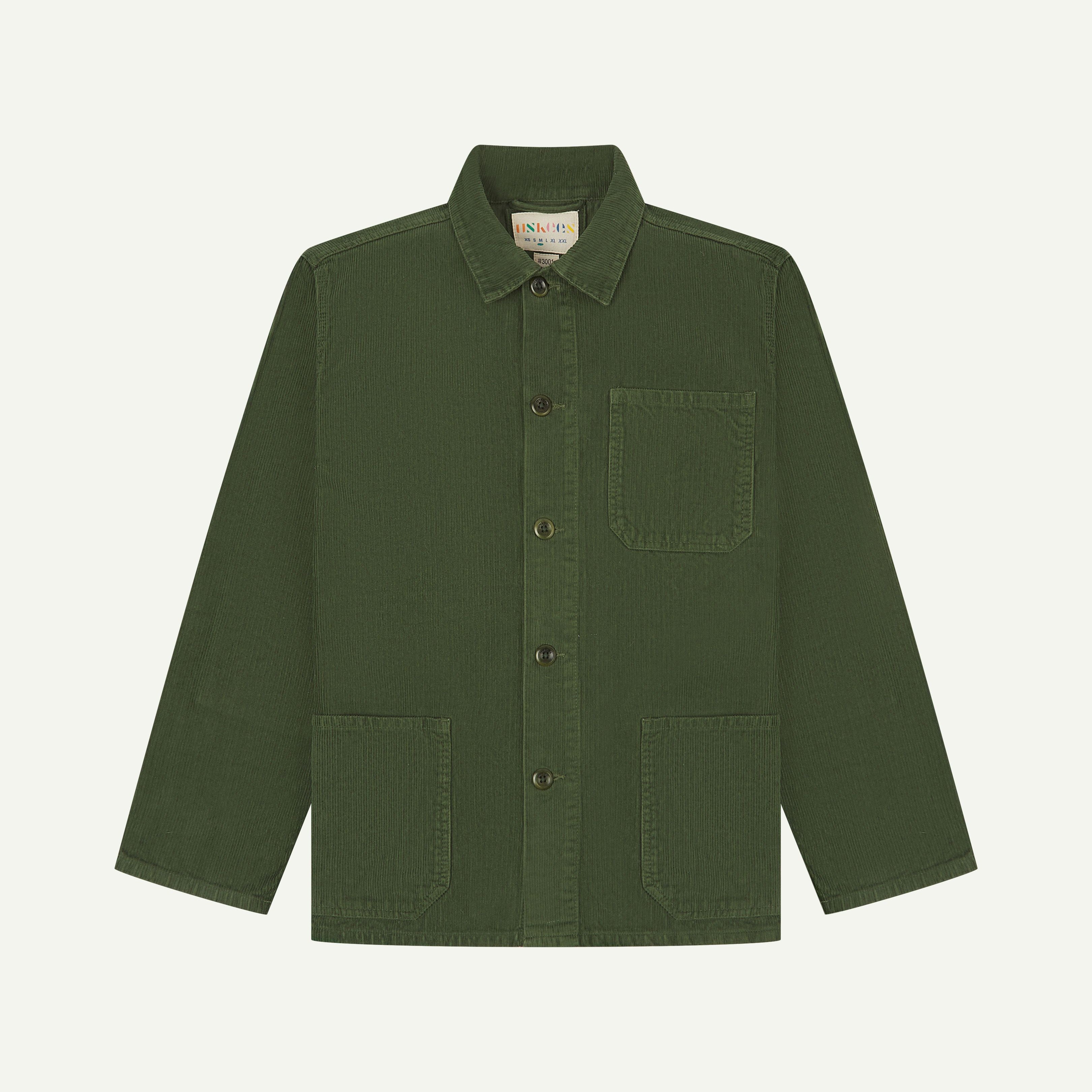 Front flat shot of mid-green, buttoned corduroy overshirt from Uskees. Clear view of corozo buttons, chest and hip pockets.