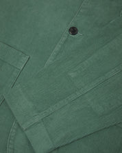 Front close view of eucalyptus-green corduroy blazer showing cuff detail.