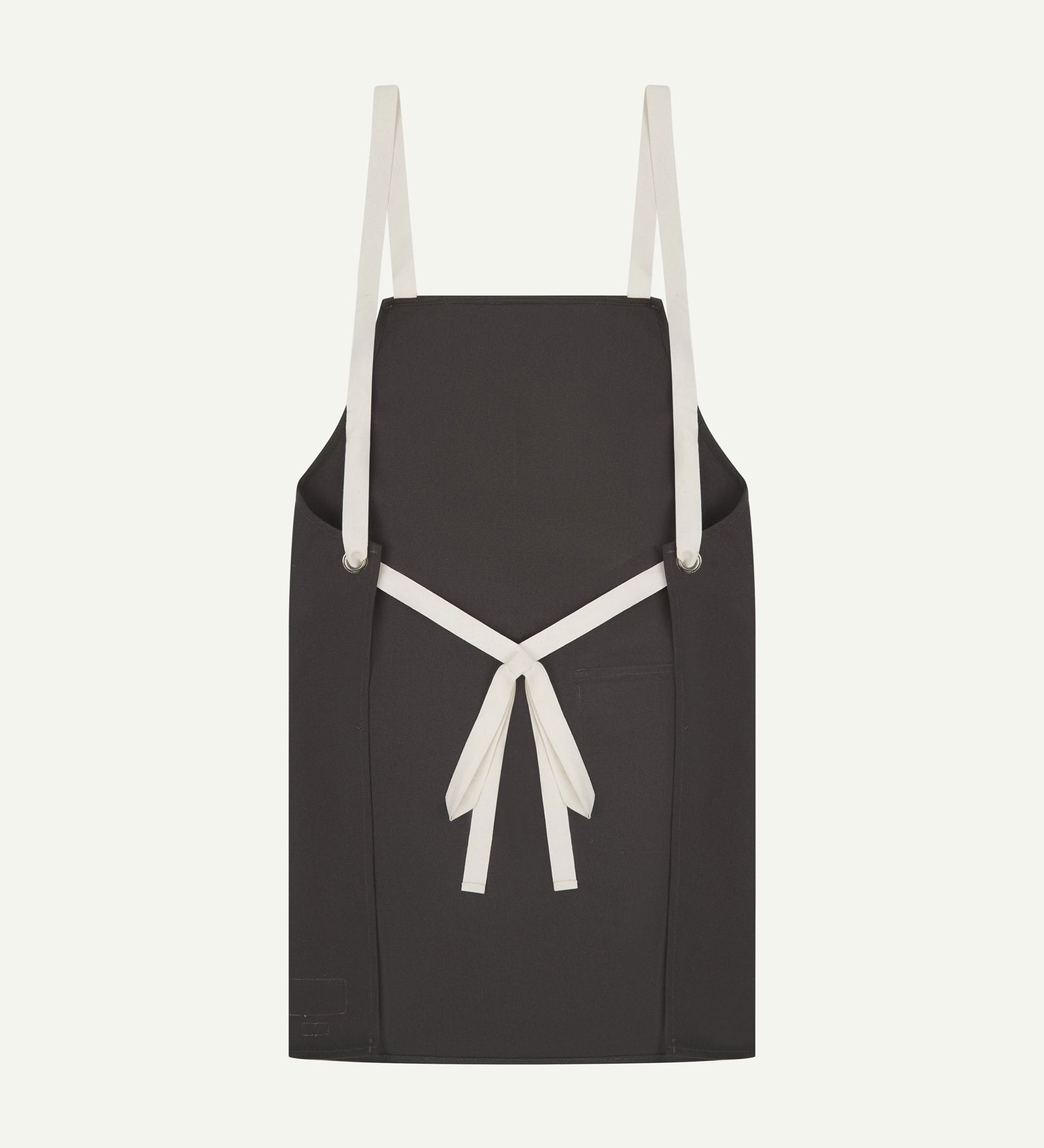 Back flat shot of Uskees unisex charcoal-grey canvas apron showing adjustable cream straps.