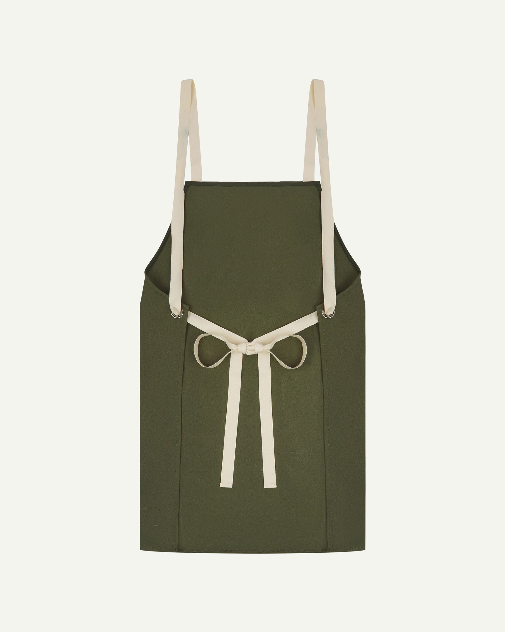 Back flat shot of Uskees unisex green canvas apron showing adjustable cream straps.
