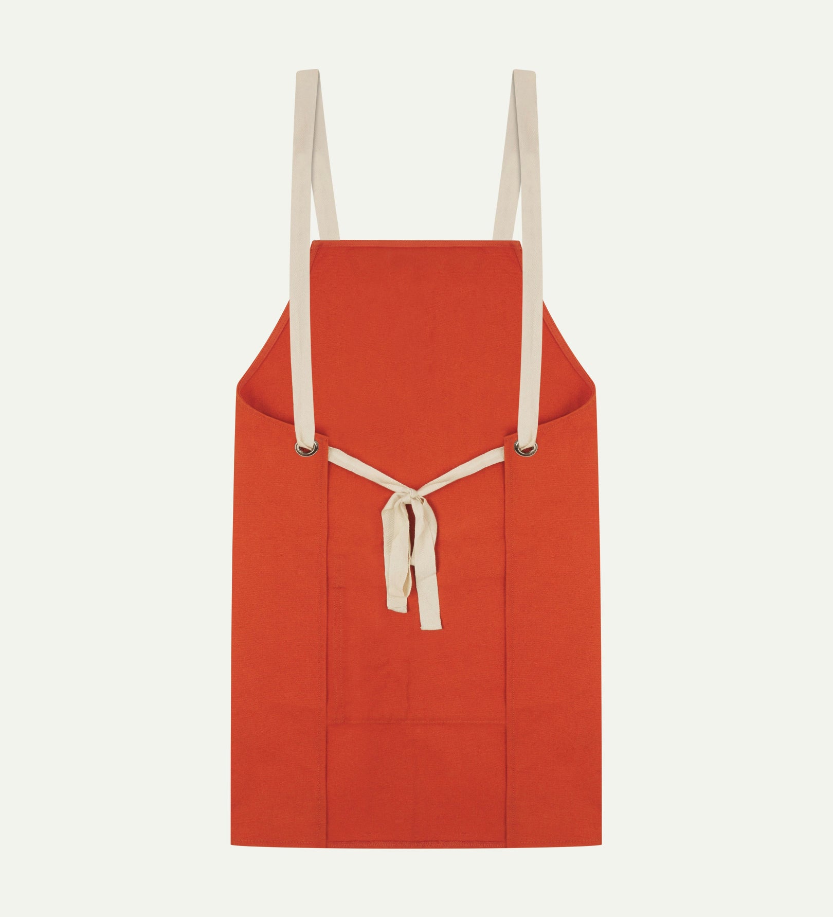 Back flat shot of Uskees unisex gold-orange canvas apron showing adjustable cream straps.