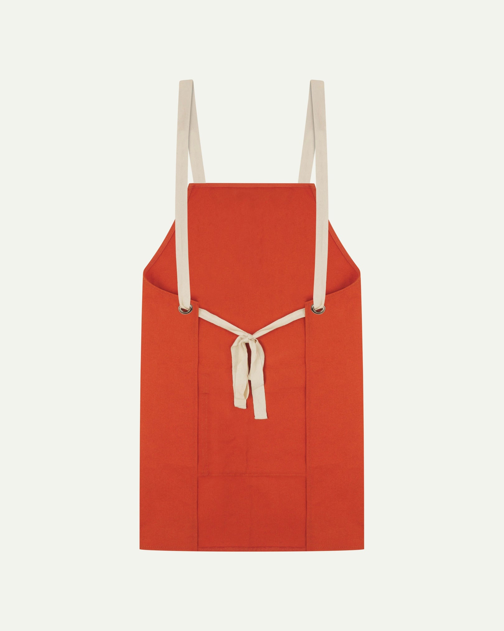 Back flat shot of Uskees unisex gold-orange canvas apron showing adjustable cream straps.