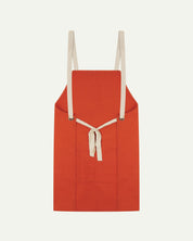 Back flat shot of Uskees unisex gold-orange canvas apron showing adjustable cream straps.