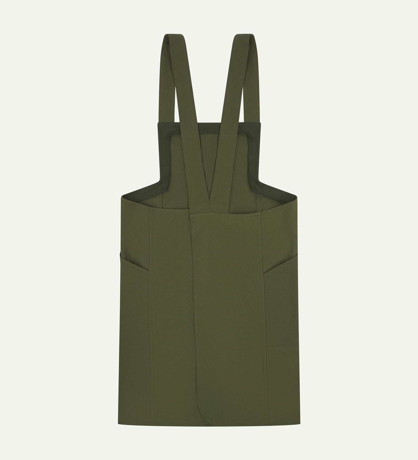 Reverse flat shot of Uskees Japanese-style 9003 coriander-green canvas apron showing straps and two side pockets.