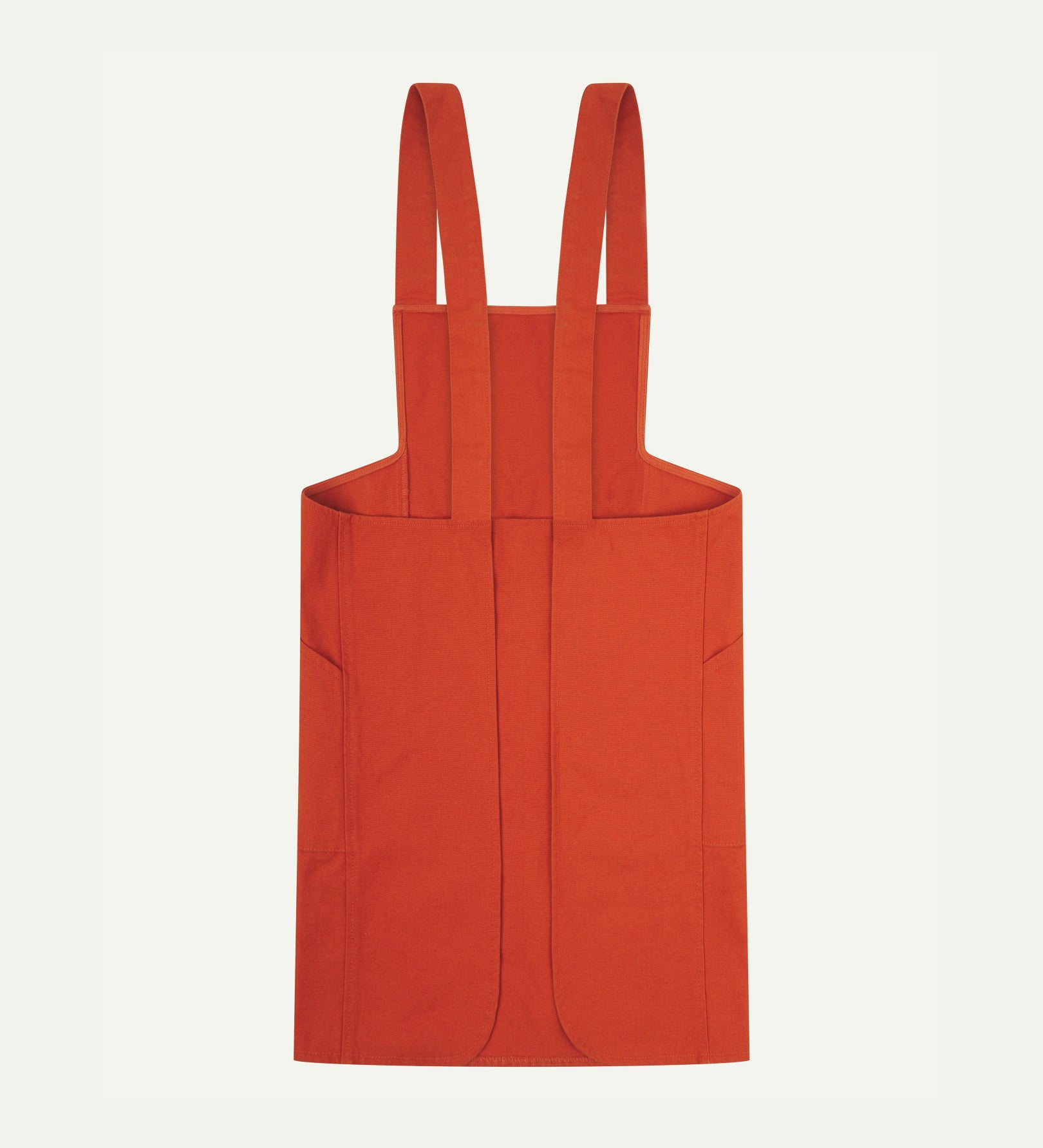 Reverse flat shot of Uskees Japanese-style 9003 gold-orange canvas apron showing straps and two side pockets.