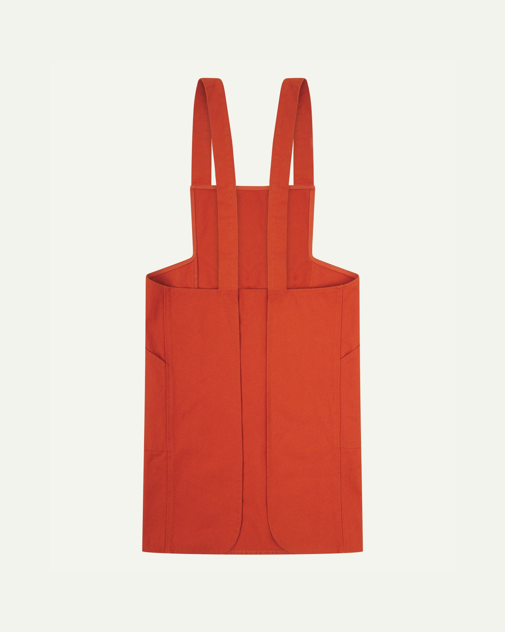 Reverse flat shot of Uskees Japanese-style 9003 gold-orange canvas apron showing straps and two side pockets.