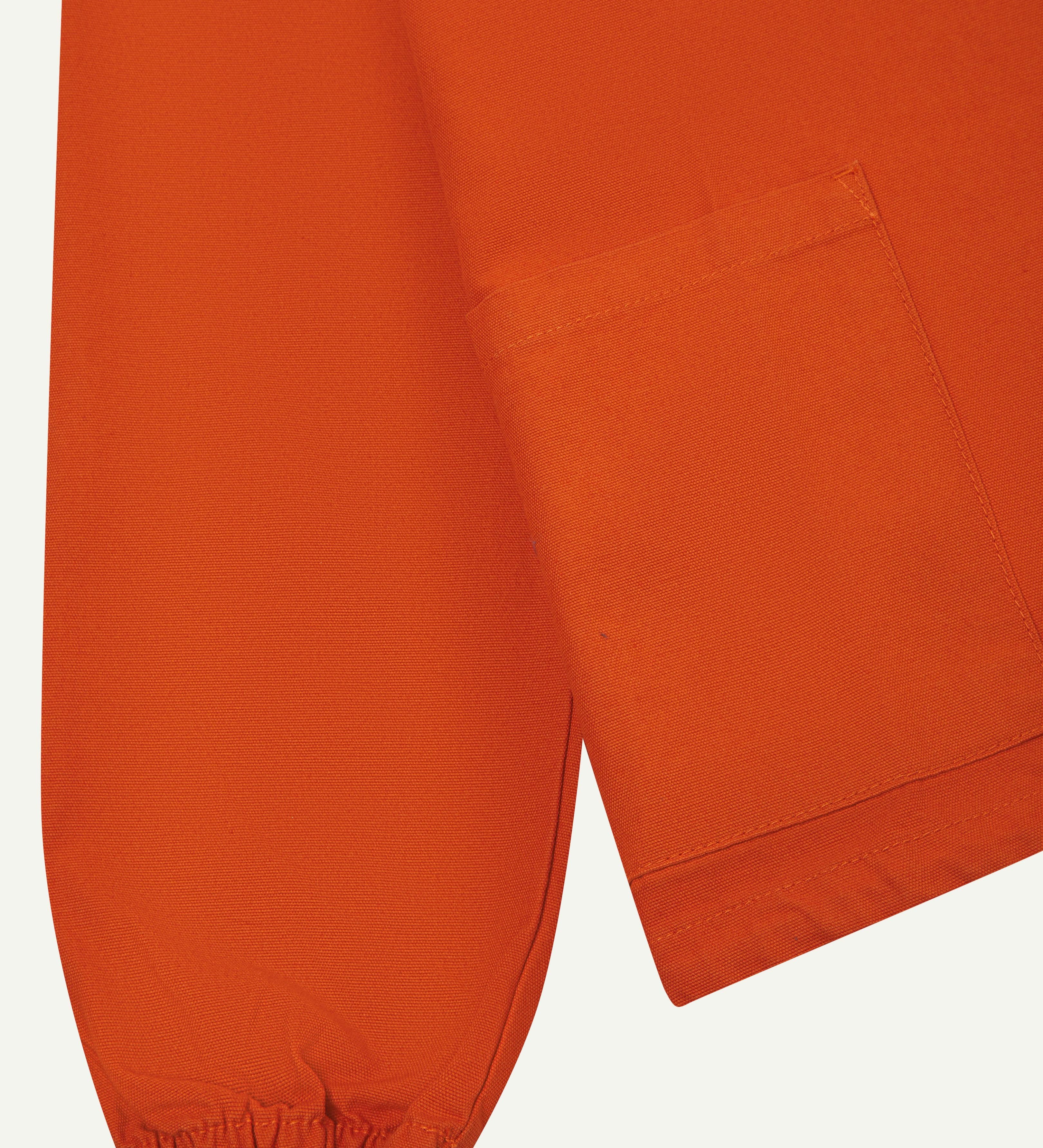 Close-up view of  sleeve and front pocket - 'gold' coloured smock from Uskees