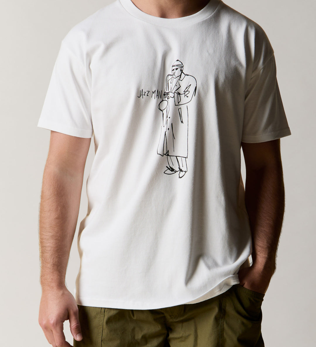 front shot of model wearing the uskees men's short sleeve graphic Tee with a black line drawing of the 'Jazz Man' on the front