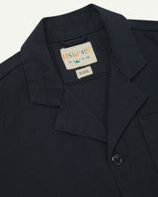 Close view of blueberry organic cotton drill blazer showing collar and Uskees branding label.