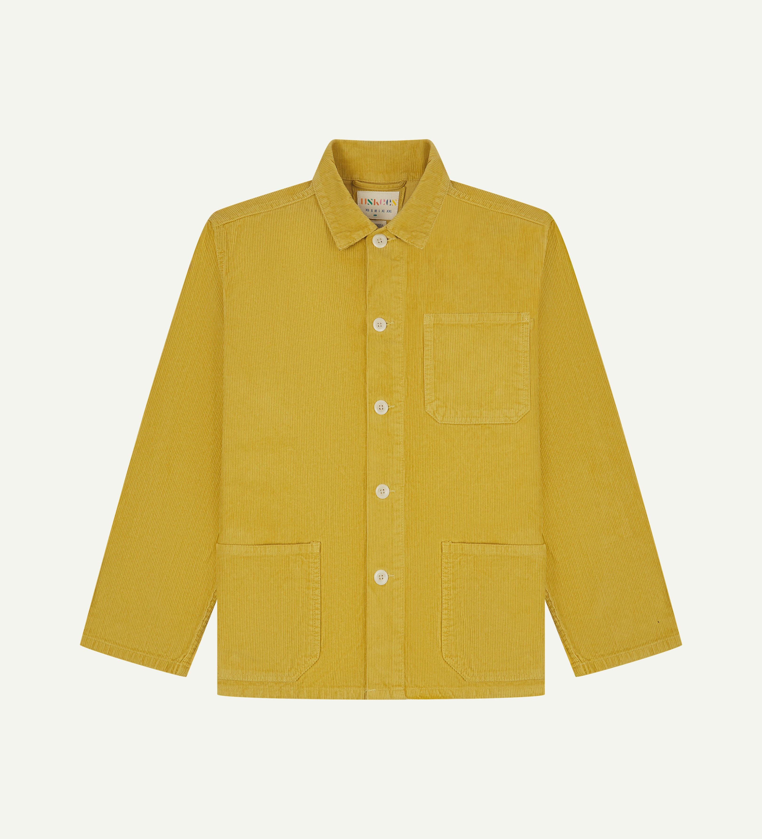 front flat shot of acid yellow coloured, buttoned corduroy overshirt from Uskees. Clear view of corozo buttons, chest and hip pockets.