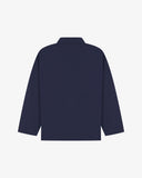 Back view of midnight blue, buttoned organic cotton overshirt with view of reinforced elbow area and boxy silhouette.