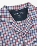 Uskees red/blue check pyjama top for men showing collar and brand label on a grey background.