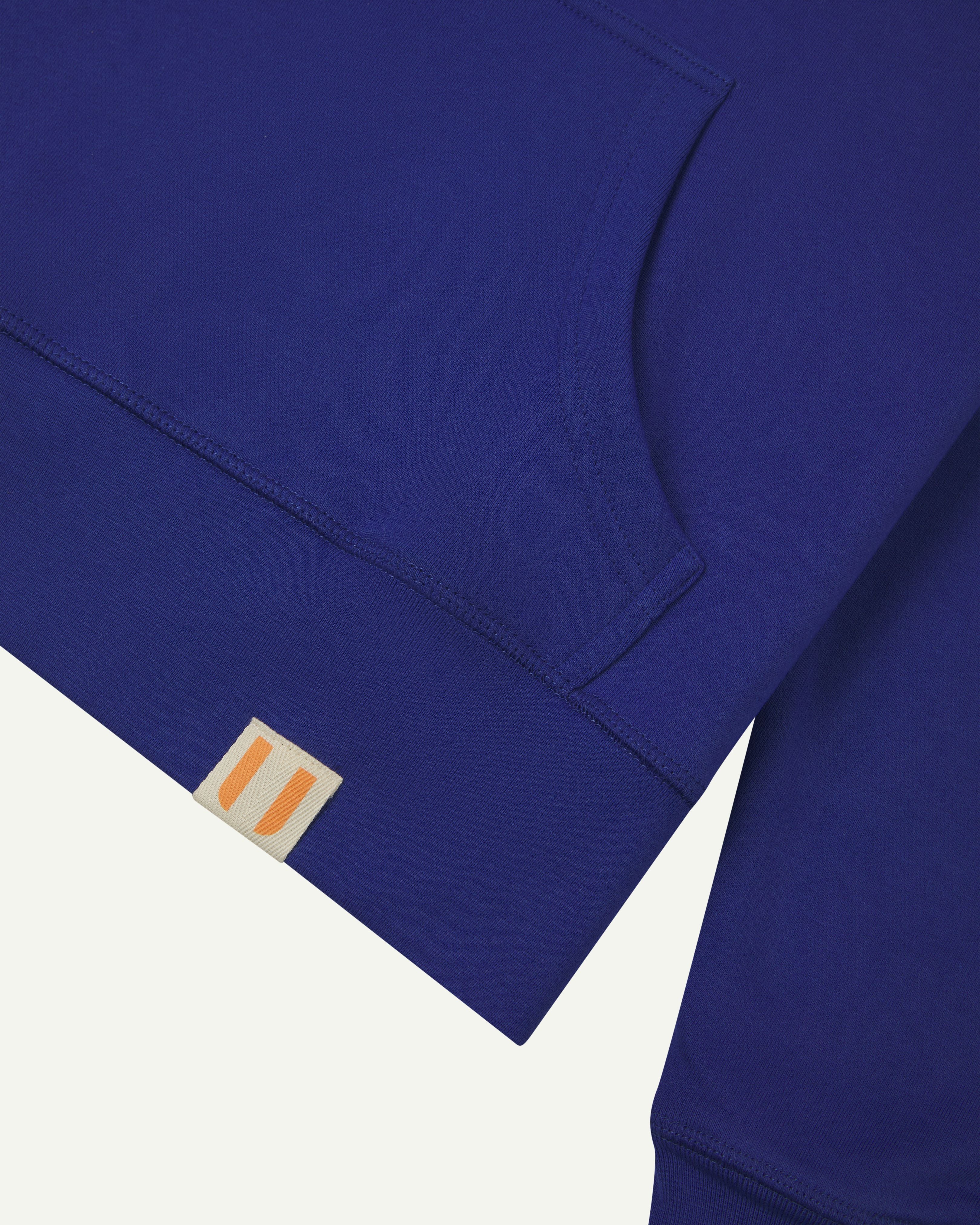 Front pocket detail view of vivid ultra blue organic cotton #7004  hooded sweatshirt by Uskees