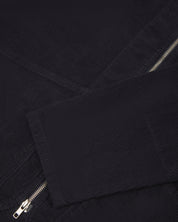 front flat shot of uskees collarless zip front jacket in dark blue corduroy showing the cuff/sleeve in close-up