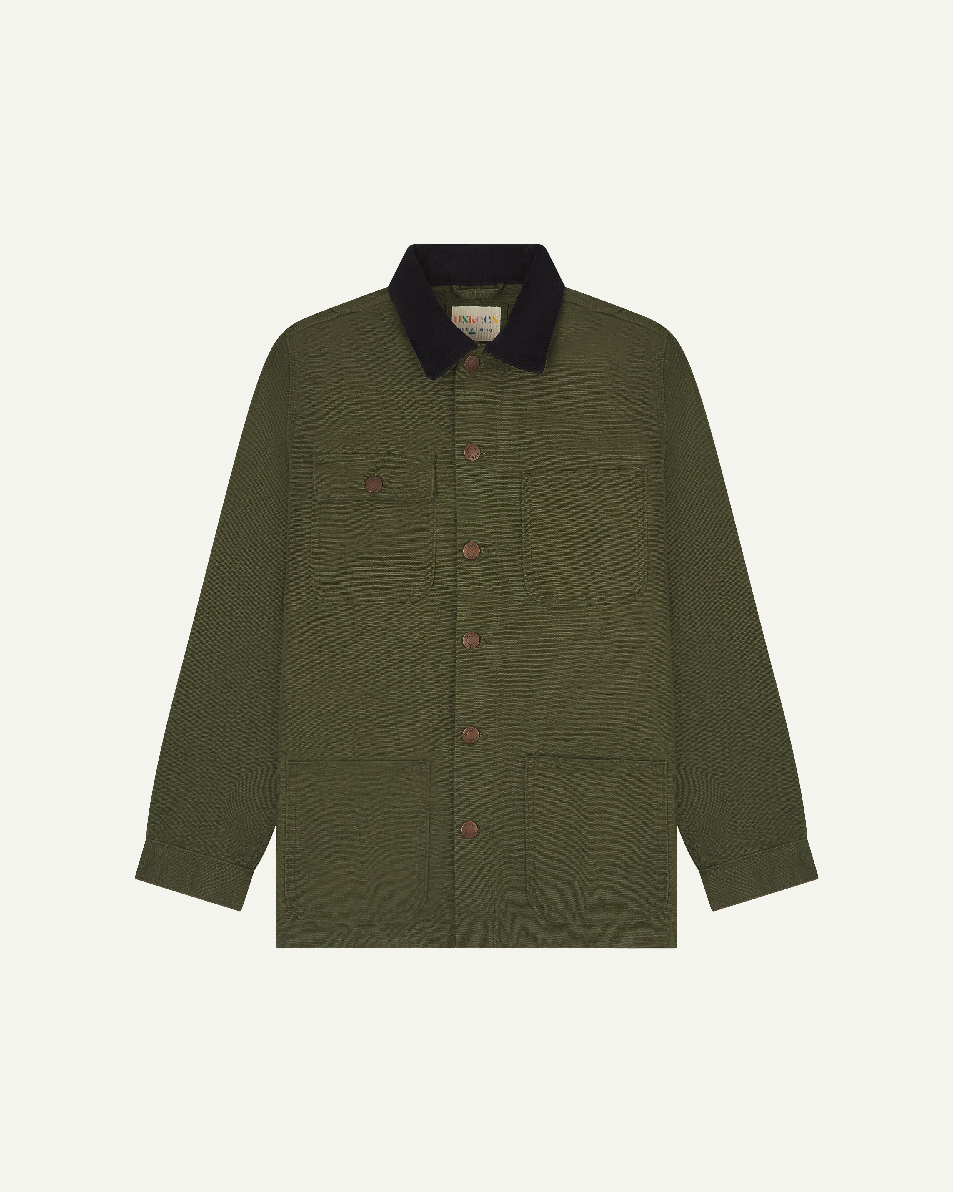 Front flat shot of uskees cotton canvas chore jacket in coriander green with a navy blue collar. Clear view of the pockets and buttons.