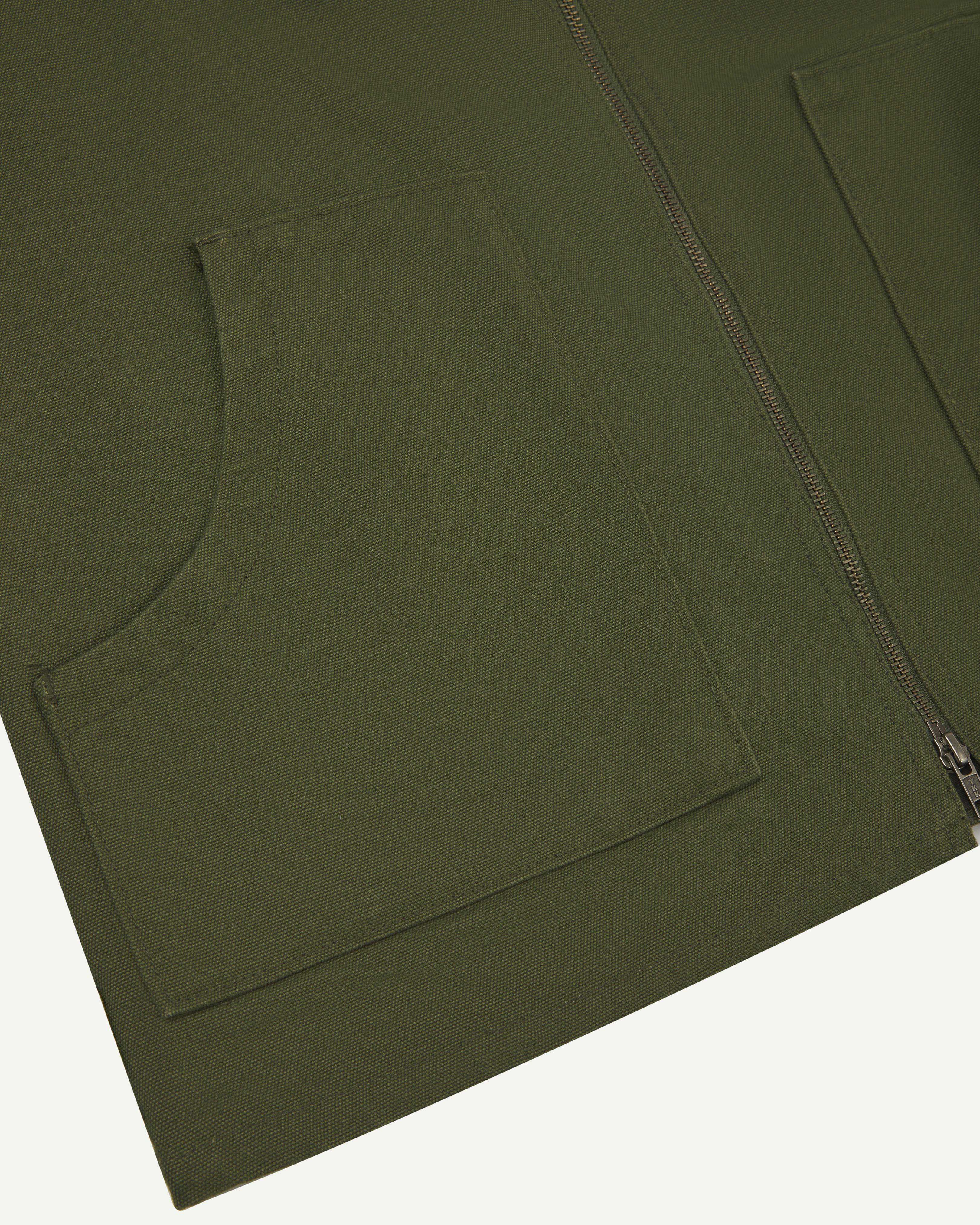 front flat close-up shot of uskees green zip front vest/waistcoat showing the front pockets and double-ended zip