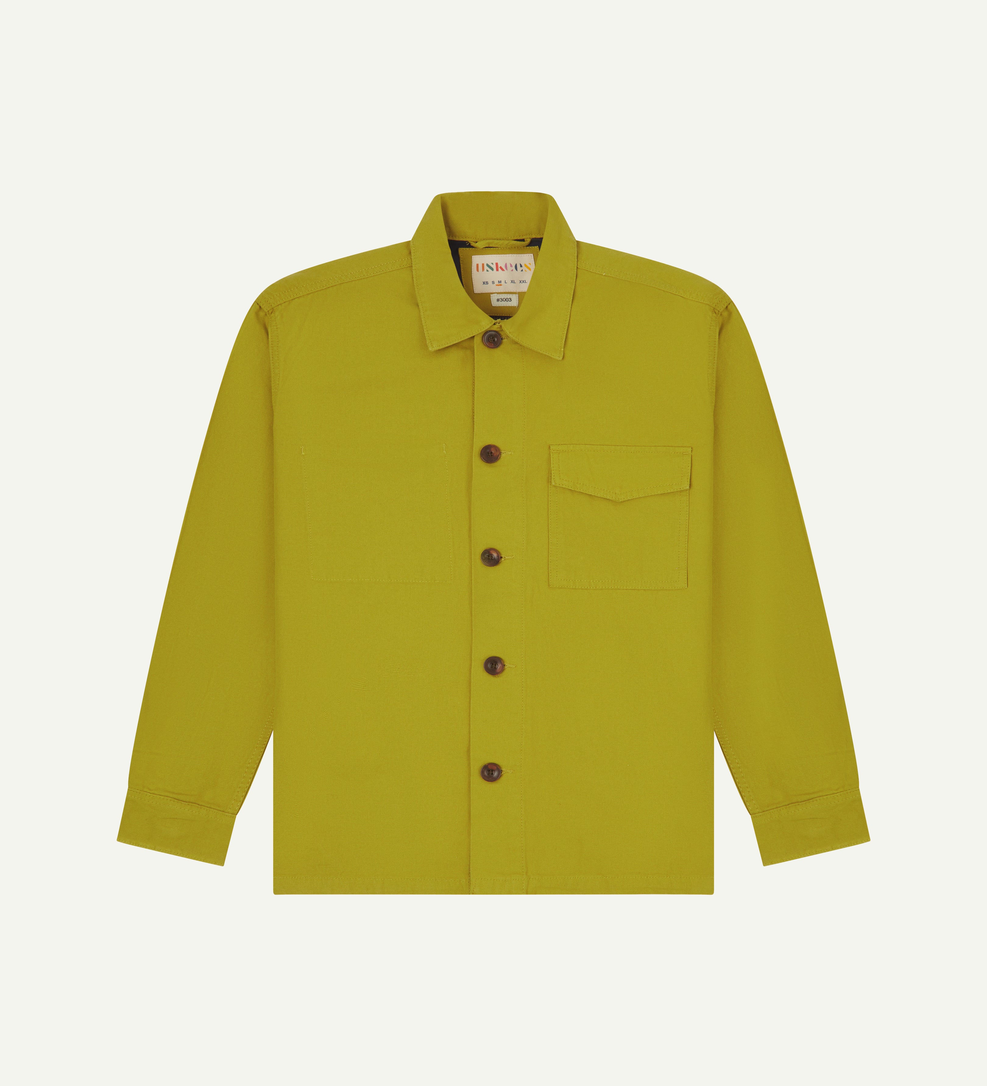 Front flat shot of uskees pear green workshirt for men showing brand label at neck