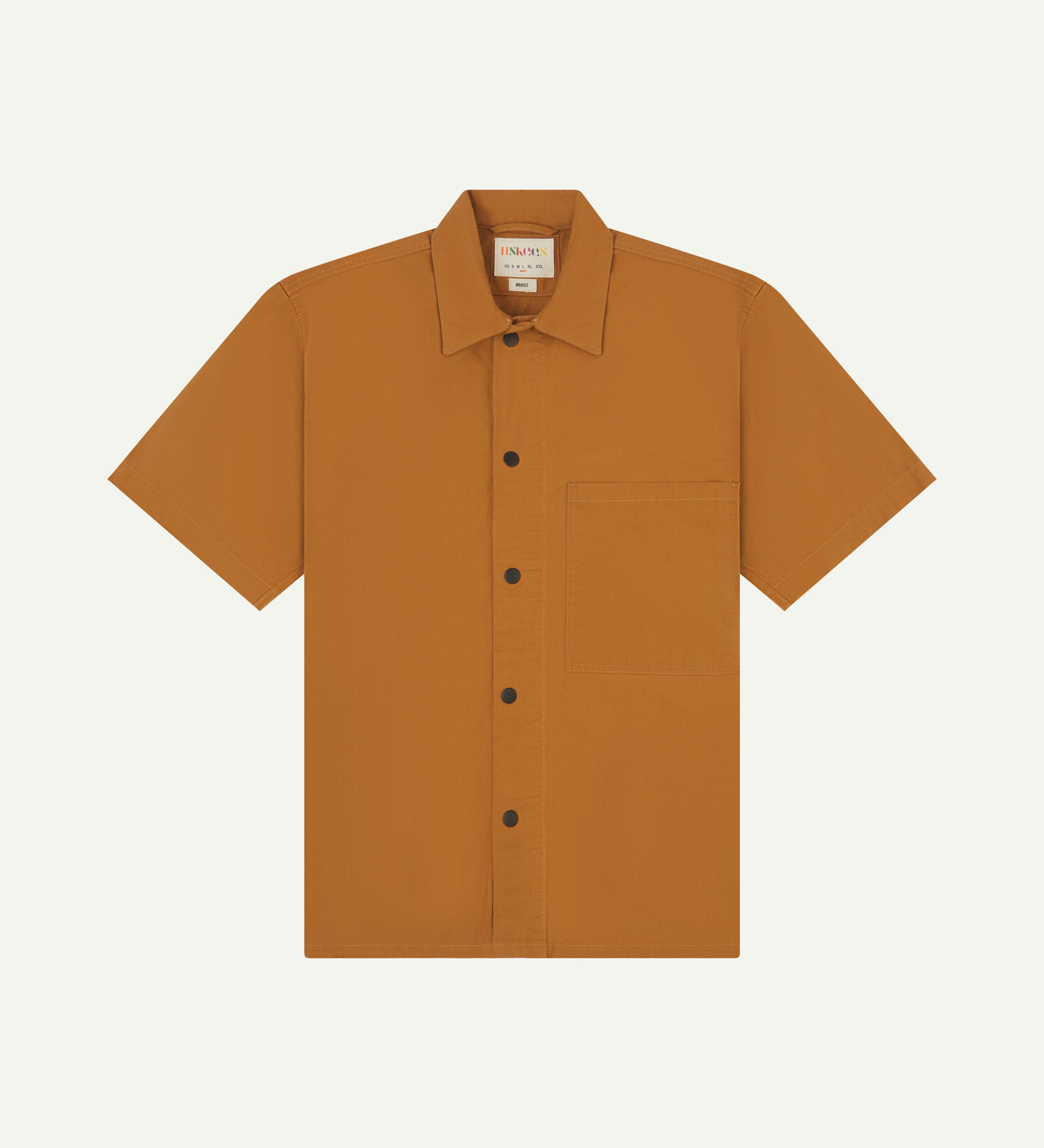 front flat shot of uskees lightweight tan men's shirt with short sleeves showing black popper fastenings