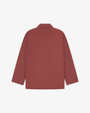 Reverse of chestnut-brown buttoned organic cotton-drill blazer from Uskees showing reinforced elbows and boxy silhouette.