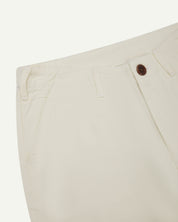 Front close-up view of #5014 Uskees men's organic cotton cream cargo trousers showing contrast brown corozo buttons at waist