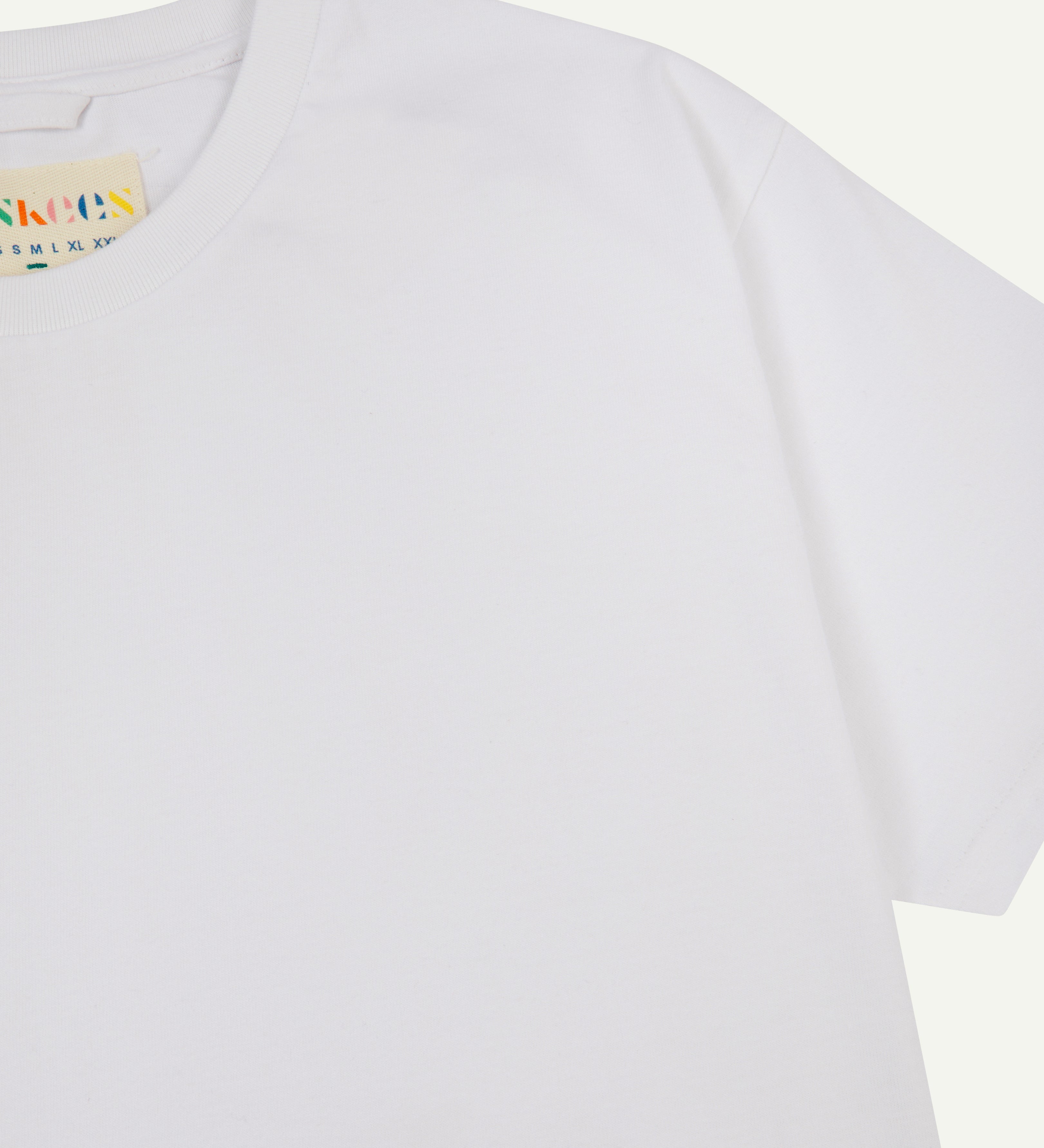 front view of uskees #7006 men's short sleeve T-shirt  in white showing part of uskees neck label.