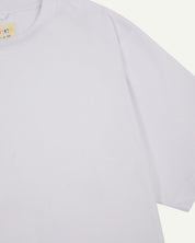 Front detail view of men's white oversized organic cotton T-shirt by Uskees