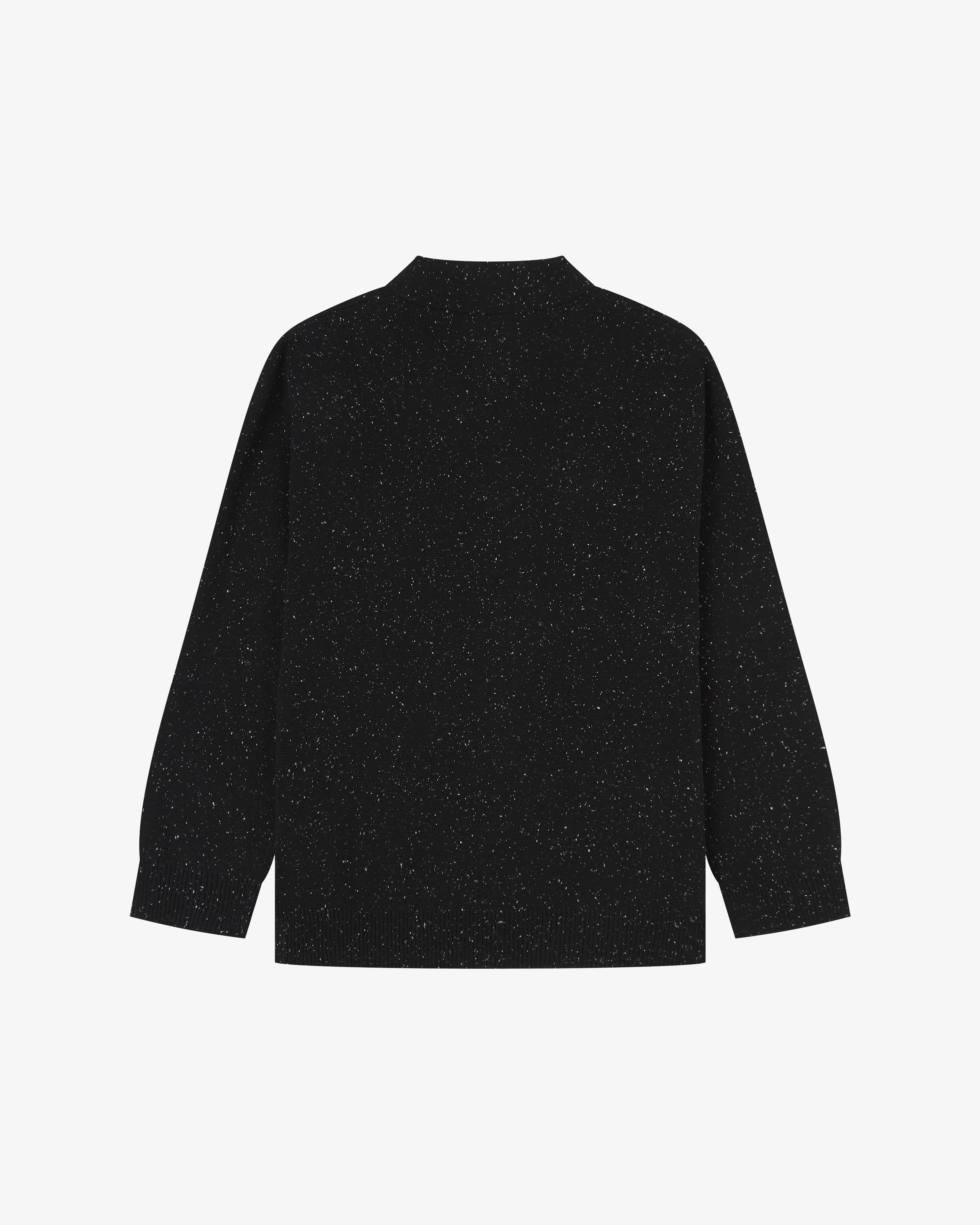 Flat back view of knitted organic cotton black cardigan from Uskees with view of ribbed cuffs and waistband