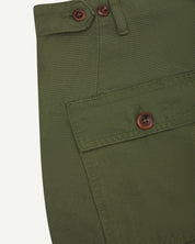 Close-up of cargo pocket detailing with corozo button of coriander-green #5014 pants from Uskees.