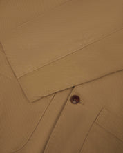 Front flat  close shot of uskees men's khaki organic cotton men's jacket showing front button fastening and sleeve