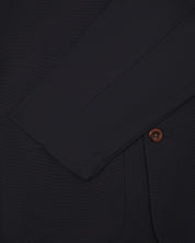 Front close view of midnight blue blazer from Uskees showing sleeve cuff and corozo button