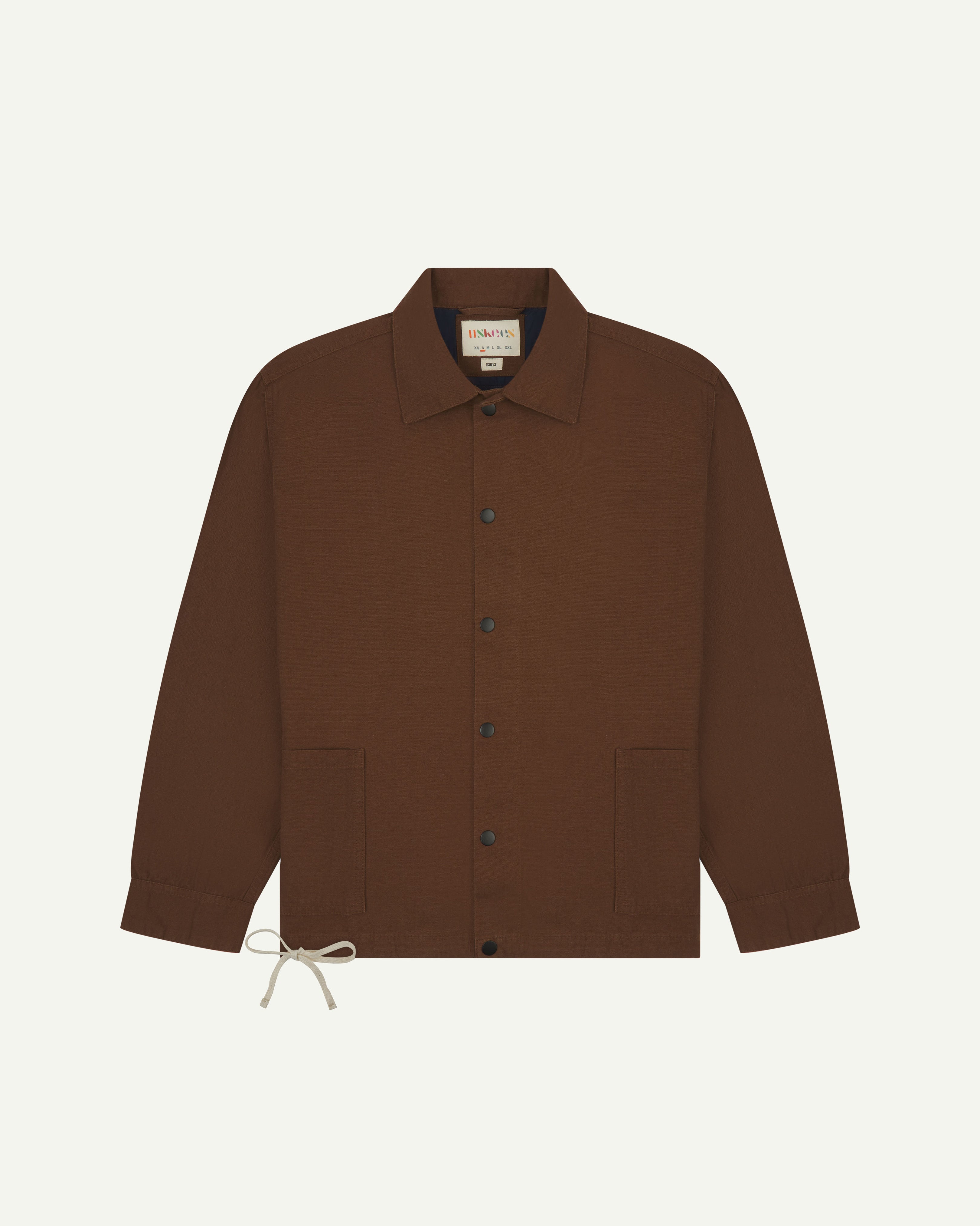 Front flat view of Uskees chocolate-brown organic cotton coach jacket with 2 patch pockets.